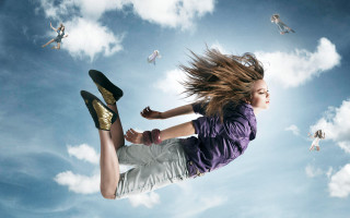 Woman flying skateboard blue sky - a skateboard in front free wallpaper