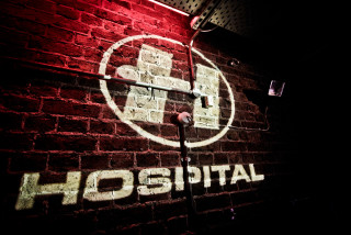 Hospital sign lit brick wall - private press free wallpaper