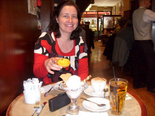 Woman sitting table food drinks - viennese actionism free wallpaper