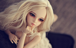 Blonde doll pearl necklace couch - a wooden floor free wallpaper
