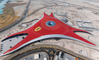Red airplane flying airport buildings - car free wallpaper