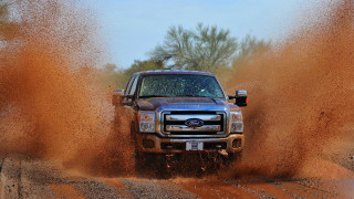 Truck driving dirt field trees - a dirt field free wallpaper