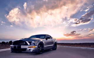 Silver car parked road cloudy - the background and a sun setting free wallpaper