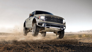 Truck jumping dirt hill desert - dust free wallpaper