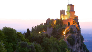 Castle hill trees lights nighttime - a pink sky in the background free wallpaper for desktop
