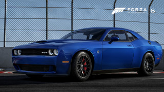Blue sports car parked fenced - realistic free wallpaper