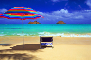 Beach chair umbrella ocean mountains - a view of the ocean and mountains free wallpaper