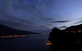 Night sky stars water mountains - a city free wallpaper