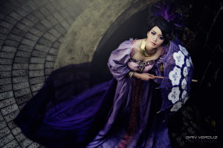 Woman purple dress umbrella tunnel - a brick wall behind her free wallpaper