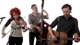 Group playing instruments singing microphones - a guitar in front free wallpaper