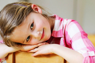 Little girl leaning wooden chair - a little girl free wallpaper
