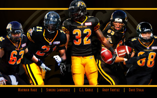 Football players group holding ball - a group of football players free wallpaper