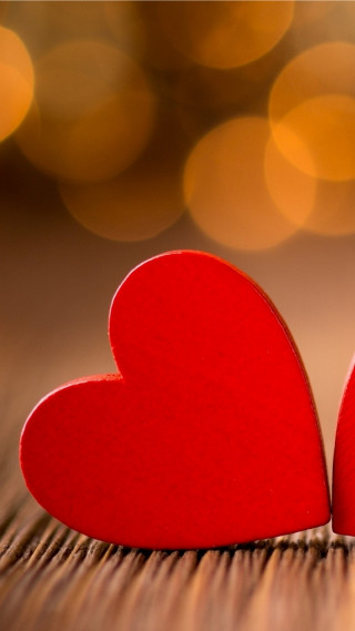 Red hearts table blurry background - free hearts wallpaper