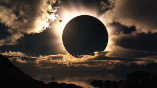 Solar eclipse water rocks foreground - a solar eclipse free wallpaper