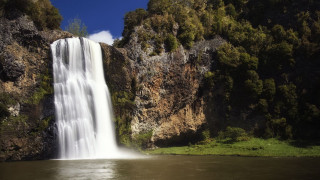 Waterfall lake boat cliff background - the middle of a lake free wallpaper