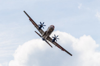 Small airplane flying cloudy sky - small free wallpaper