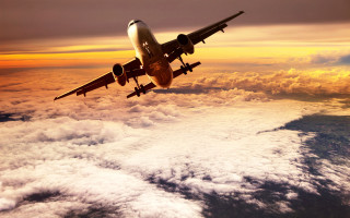 Jetliner cloudy sky sunset ocean - a cloudy sky above the clouds free wallpaper