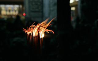 Lit candle dark background blurry - the background in the background free wallpaper