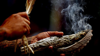 Person holding feather pipe smoke - free new year wallpaper