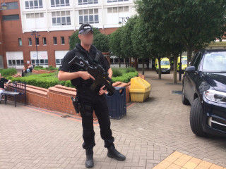 Man police uniform gun courtyard - nearby free wallpaper
