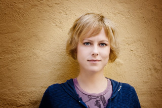 Woman yellow wall blue jacket - a purple shirt free wallpaper