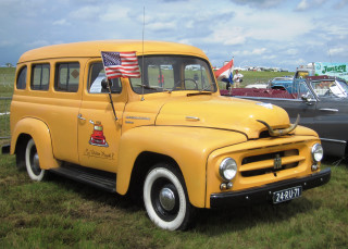 Yellow truck parked field cars - a yellow truck free wallpaper