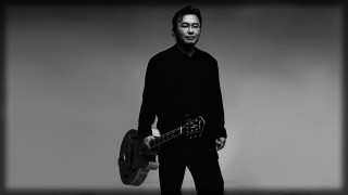 Man holding two guitars black - hand free wallpaper