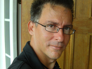 Man glasses black shirt smiling - free portrait wallpaper