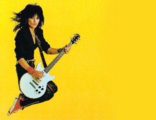Woman jumping guitar yellow background - eric taylor free wallpaper