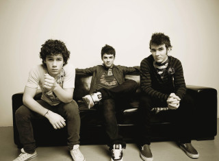 Three young men couch white - one man free wallpaper