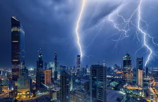 Lightning bolt strikes city night - over a city free wallpaper