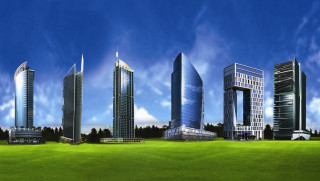 Tall buildings lush green field - a forest of trees free wallpaper