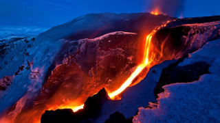 Lava flow sky bright orange - side and a mountain in the background free wallpaper