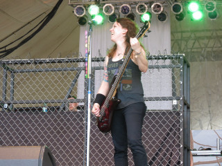 Woman stage guitar microphone performance - a guitar free wallpaper