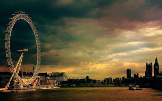 Ferris wheel river cloudy sky 5 - a city skyline in the background free wallpaper