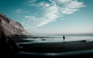 Beach cliff water sky clouds 2 - a person free wallpaper