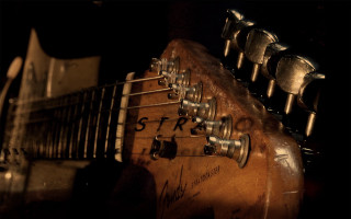 Guitar closeup black background 2 - a close up of a guitar free wallpaper