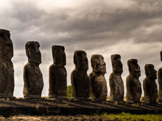 Moai statues field cloudy sky - a field under a cloudy sky free wallpaper