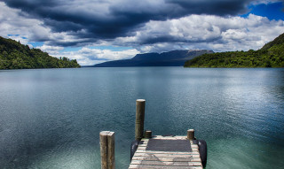 Dock lake mountains clouds water - a body of water below free wallpaper