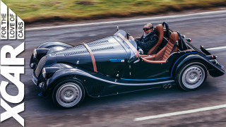 Man driving vintage car road - a vintage car free wallpaper