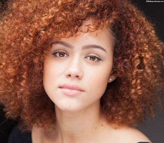 Red curly hair serious woman - free portrait wallpaper