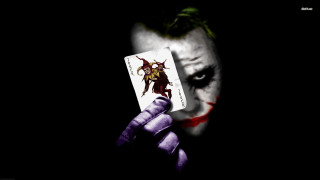 Joker holding card joker face - the gathering free wallpaper