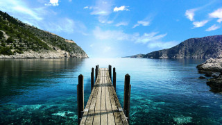 Pier ocean mountains blue water - blue water free wallpaper