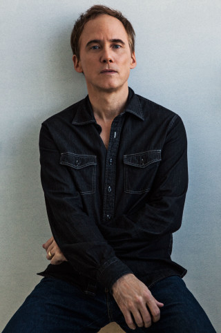 Man stool hands hips serious - studio portrait free wallpaper
