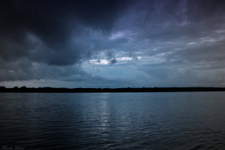 Water sky clouds boat reflection 2 - dark atmosphere free wallpaper