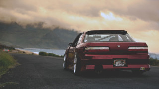 Red car parked ocean mountains - scenery free wallpaper