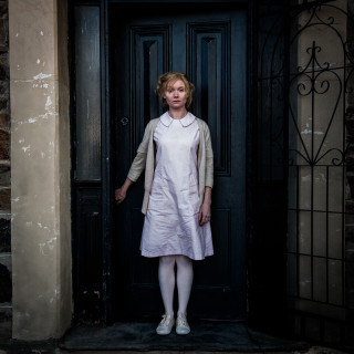 Woman white dress black door - front free wallpaper