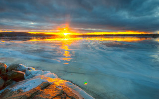 Sunset frozen lake rocks ice - the water free wallpaper