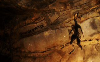 Climber shadow unknown rock face - primitivism free wallpaper