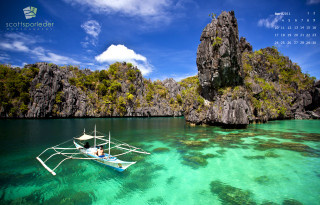 Boat water rocky cliff calendar - a boat floating free wallpaper